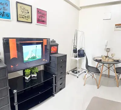 a living room with a tv and a table at Maiko Happy Studio near US Embassy in Manila