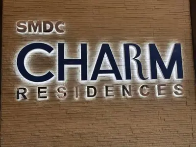 a sign on the side of a building with the words clhamresres at Charm Residences Staycation by Ashti in Manila