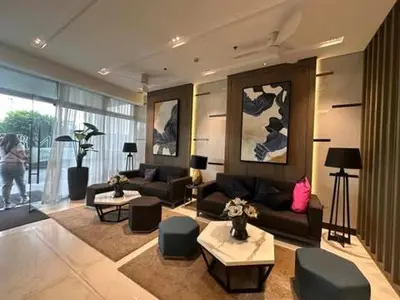a living room with a couch and tables and chairs at Charm Residences Staycation by Ashti in Manila