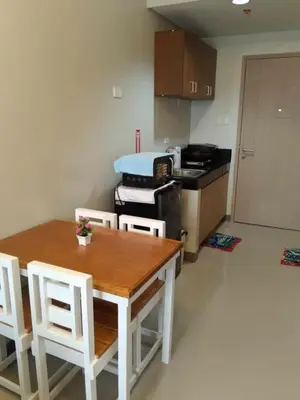a kitchen with a table and chairs and a stove at Charm Residences Staycation by Ashti in Manila