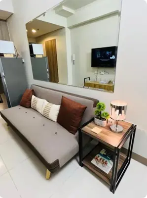a living room with a couch and a table at Coast Residences in Manila