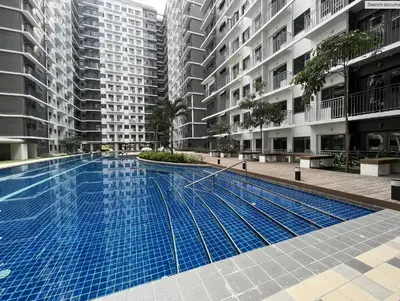 an empty swimming pool in a building with tall buildings at Shore 3 Tower 2 near MOA Parking WI-FI Netflix in Manila