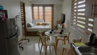 a small room with a bed and a table and chairs at Shore 3 Tower 2 near MOA Parking WI-FI Netflix in Manila