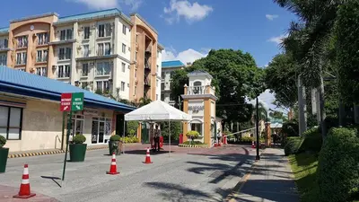 a street with orange and white cones and buildings at Compact Urban Studio-Type Unit in Manila