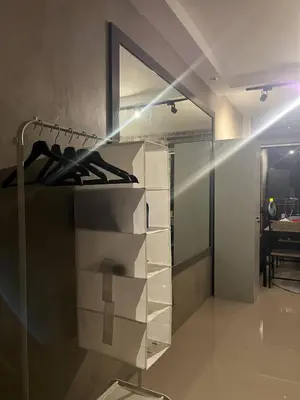 a room with a glass shelf with shoes in it at Compact Urban Studio-Type Unit in Manila