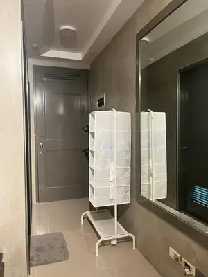 a bathroom with a mirror and a towel rack at Compact Urban Studio-Type Unit in Manila