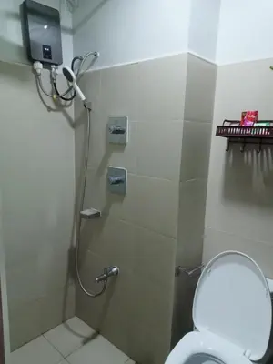a bathroom with a shower stall with a toilet at Shore 3 Residences Staycation in Manila