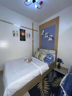 a bedroom with a bed with a white bedspread at Shore 3 Residences Staycation in Manila