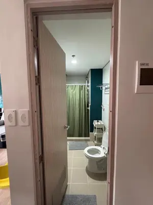 an open door to a bathroom with a toilet at SMDC Park Residences Unit 202 in Ibaba