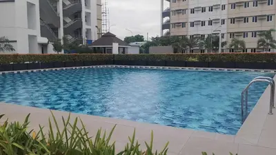 a swimming pool in the middle of a building at SMDC Park Residences Unit 202 in Ibaba