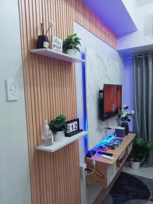 a room with a desk with plants and a tv at Shore 3 Residences Staycation in Manila