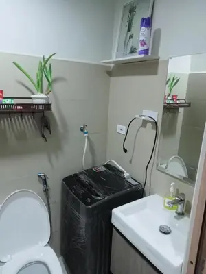 a small bathroom with a toilet and a sink at Shore 3 Residences Staycation in Manila