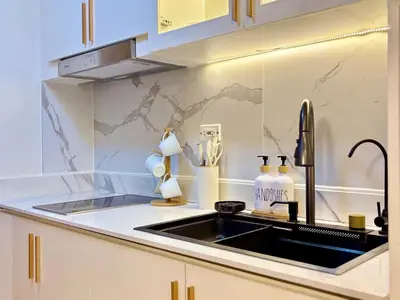 a kitchen with a sink and a counter top at Elegant Staycation Near Mall of Asia with Pool Access in Manila