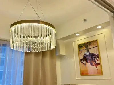 a chandelier hanging from a ceiling in a room at Elegant Staycation Near Mall of Asia with Pool Access in Manila