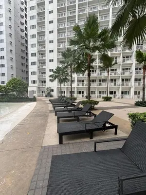 a row of benches in front of a large building at Hiraya Staycation in Manila