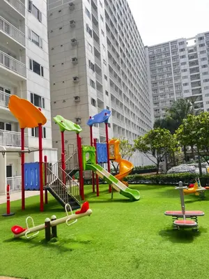 a playground in a park in front of a building at Hiraya Staycation in Manila