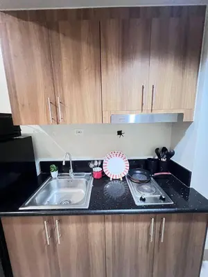 a kitchen counter with a sink and a stove at UNISTAY Shore 3 Tower 2 Pool Vw w Bal in Manila