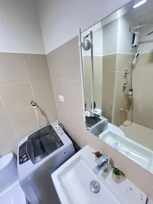 a bathroom with a sink and a toilet and a mirror at UNISTAY Shore 3 Tower 2 Pool Vw w Bal in Manila