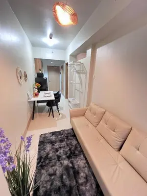 a living room with a couch and a table at UNISTAY Shore 3 Tower 2 Pool Vw w Bal in Manila