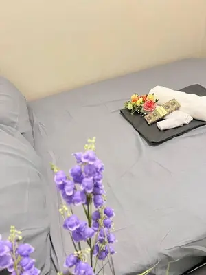 a bed with purple flowers on top of it at UNISTAY Shore 3 Tower 2 Pool Vw w Bal in Manila