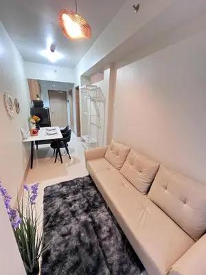 a living room with a couch and a table at UNISTAY Shore 3 Tower 2 Pool Vw w Bal in Manila