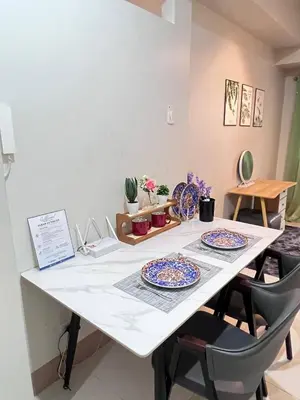 a white table with two blue and white plates on it at UNISTAY Shore 3 Tower 2 14 Flr w Bal in Manila