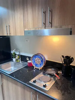 a kitchen counter with a stove and a sink at UNISTAY Shore 3 Tower 2 14 Flr w Bal in Manila
