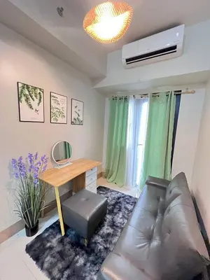 a living room with a couch and a desk at UNISTAY Shore 3 Tower 2 14 Flr w Bal in Manila