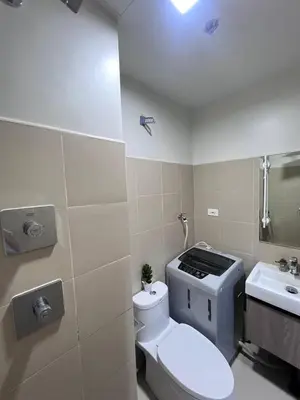 a bathroom with a toilet and a sink at UNISTAY Shore 3 Tower 2 14 Flr w Bal in Manila