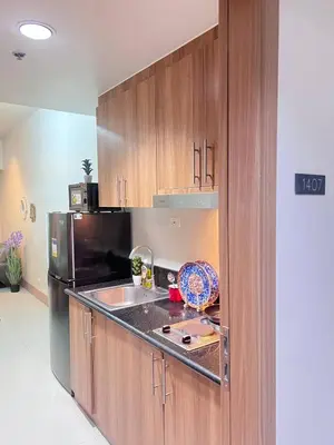 a kitchen with a sink and a refrigerator at UNISTAY Shore 3 Tower 2 14 Flr w Bal in Manila