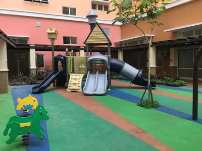 a playground in a building with a slide at Happy Nook at Holland Park Condominium in Biñan