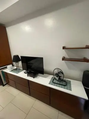 a room with a desk with a flat screen tv at Antel Spa Residences 2505 in Manila