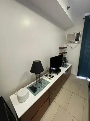 a room with a desk with a computer on it at Antel Spa Residences 2505 in Manila