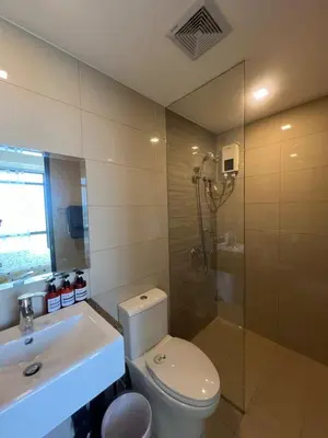 a bathroom with a toilet and a sink and a shower at Okada Manila Gentry Manor Balcony 1br Unobstructed Scenic View in Manila