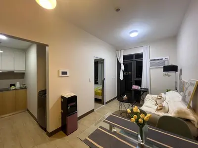 a living room with a dog laying on a couch at Okada Manila Gentry Manor Balcony 1br Unobstructed Scenic View in Manila