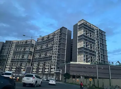 two tall buildings on a city street with cars at Okada Manila Gentry Manor Balcony 1br Unobstructed Scenic View in Manila