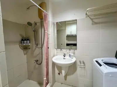 a small bathroom with a sink and a shower at Sea Residences Pasay Cozy Studio Steps from SM Mall of Asia and MOA Arena in Manila
