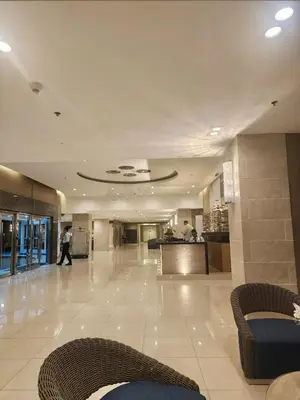 a lobby with a person walking in a building at Sea Residences Pasay Cozy Studio Steps from SM Mall of Asia and MOA Arena in Manila