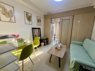 a living room with a couch and a table at Shore Residences Pasay Balcony Studio Unobstructed View Near SM Mall of Asia in Manila