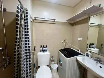 a bathroom with a toilet and a sink at Shore Residences Pasay Balcony Studio Unobstructed View Near SM Mall of Asia in Manila