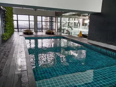 a large swimming pool in a building at Gramercy Makati Condotel in Manila