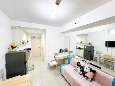 a large living room with a couch and a kitchen at Sea Residences Navigators in Manila