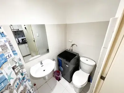 a small bathroom with a toilet and a sink at Sea Residences Navigators in Manila