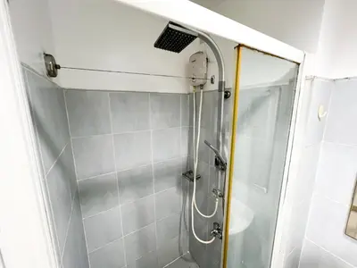 a shower with a glass door in a bathroom at Sea Residences Navigators in Manila