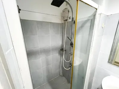 a shower with a glass door in a bathroom at Sea Residences Navigators in Manila
