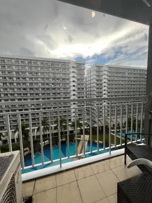 a view of a large apartment building from a balcony at Shell Residences near MOA and NAIA by Mae in Manila