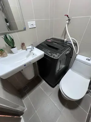 a bathroom with a toilet and a sink at UNISTAY Coast Res R19 w Bal Sunset Vw Worldtrade in Manila