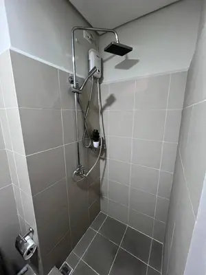 a bathroom with a shower with a plant in it at UNISTAY Coast Res R19 w Bal Sunset Vw Worldtrade in Manila