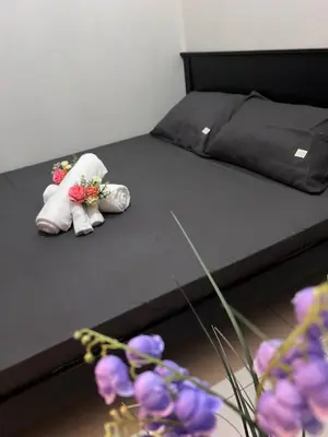 two stuffed animals on a bed with flowers on it at UNISTAY Coast Res R19 w Bal Sunset Vw Worldtrade in Manila