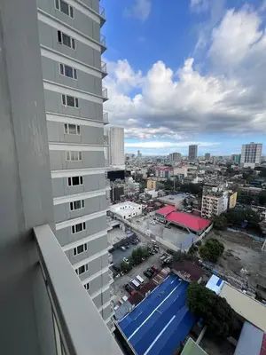 a view of a city from the balcony of a building at UNISTAY Coast Res R19 w Bal Sunset Vw Worldtrade in Manila